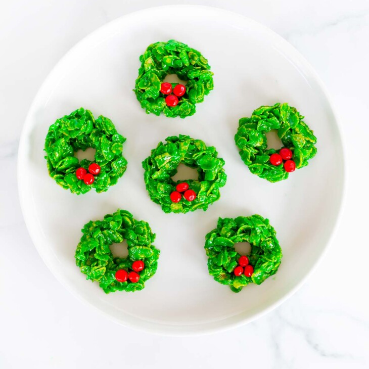 christmas wreath cookies on white plate