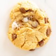 A single homemade marshmallow cookie on a marble surface.