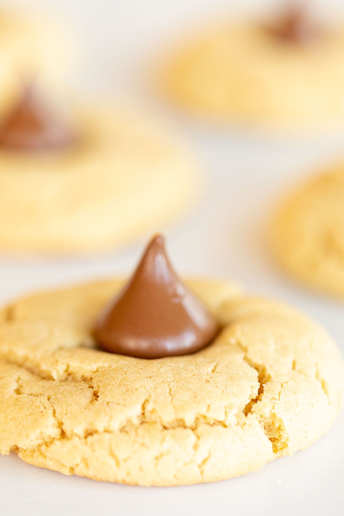 Peanut butter blossoms on a white marble surface.
