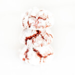 stack of red cookies covered in powdered sugar