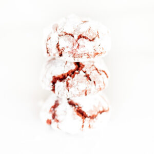 stack of red cookies covered in powdered sugar