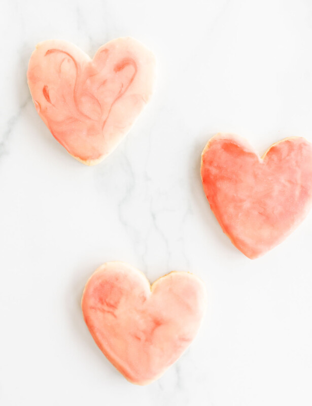 3 heart shaped sugar cookies on marble surface