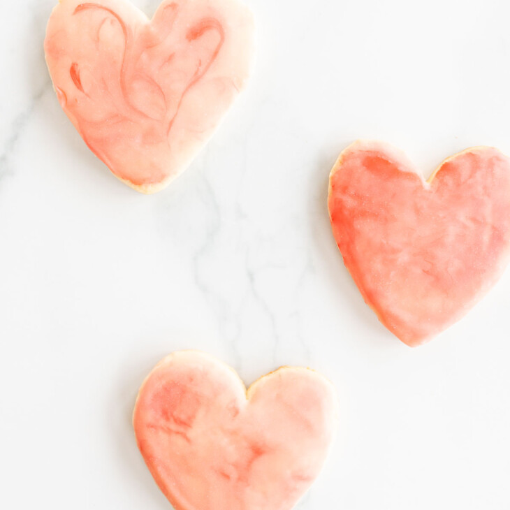 3 heart shaped sugar cookies on marble surface