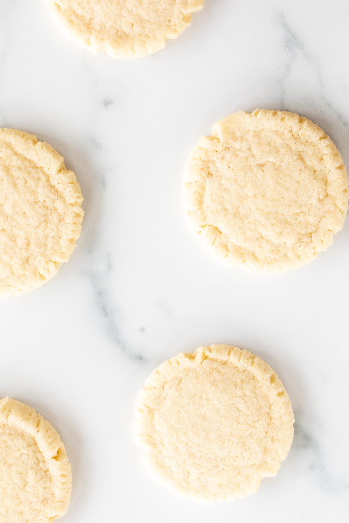 classic sugar cookies scattered on marble surface