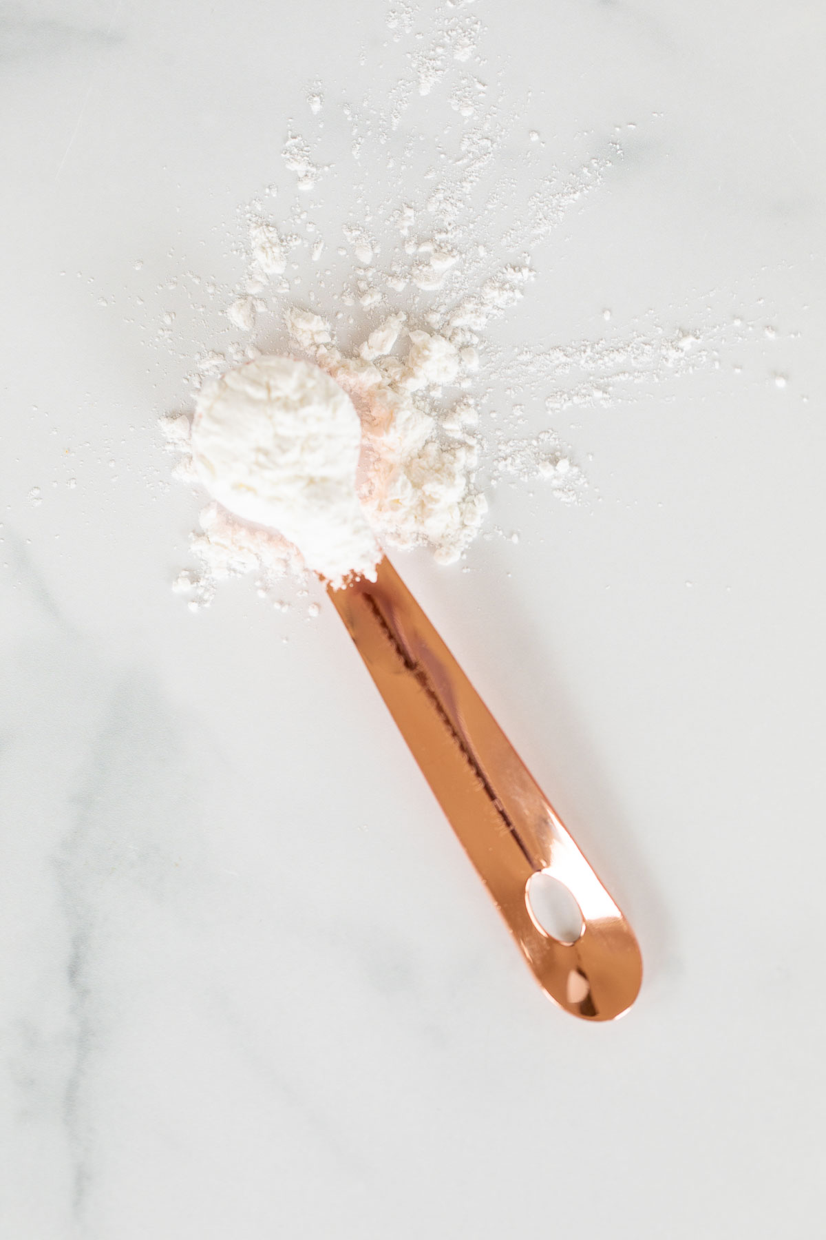 measuring spoon with white powder on it