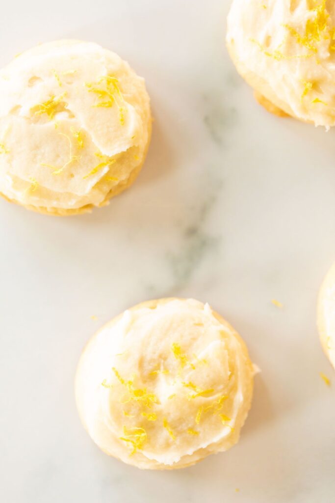 Frosted lemon cookies on a marble surface