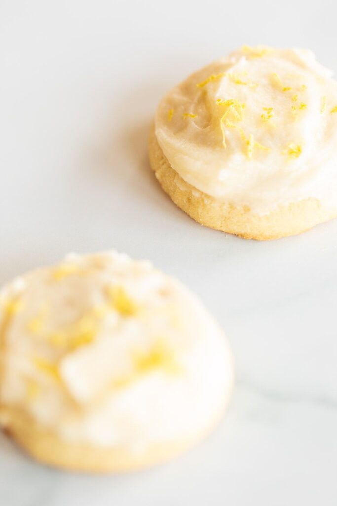 Frosted lemon cookies on a marble surface