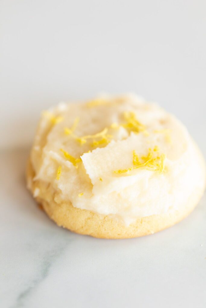 Frosted lemon cookie on a marble surface