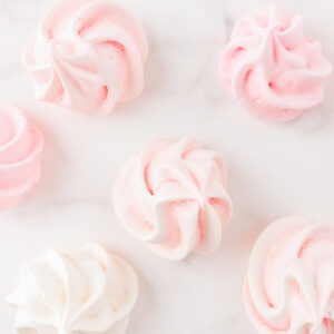 pink and cream meringues on marble surface