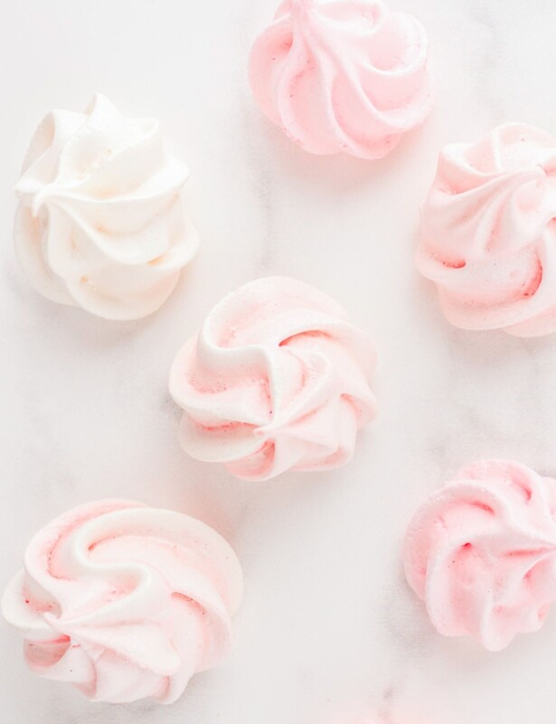 pink meringues scattered on white marble