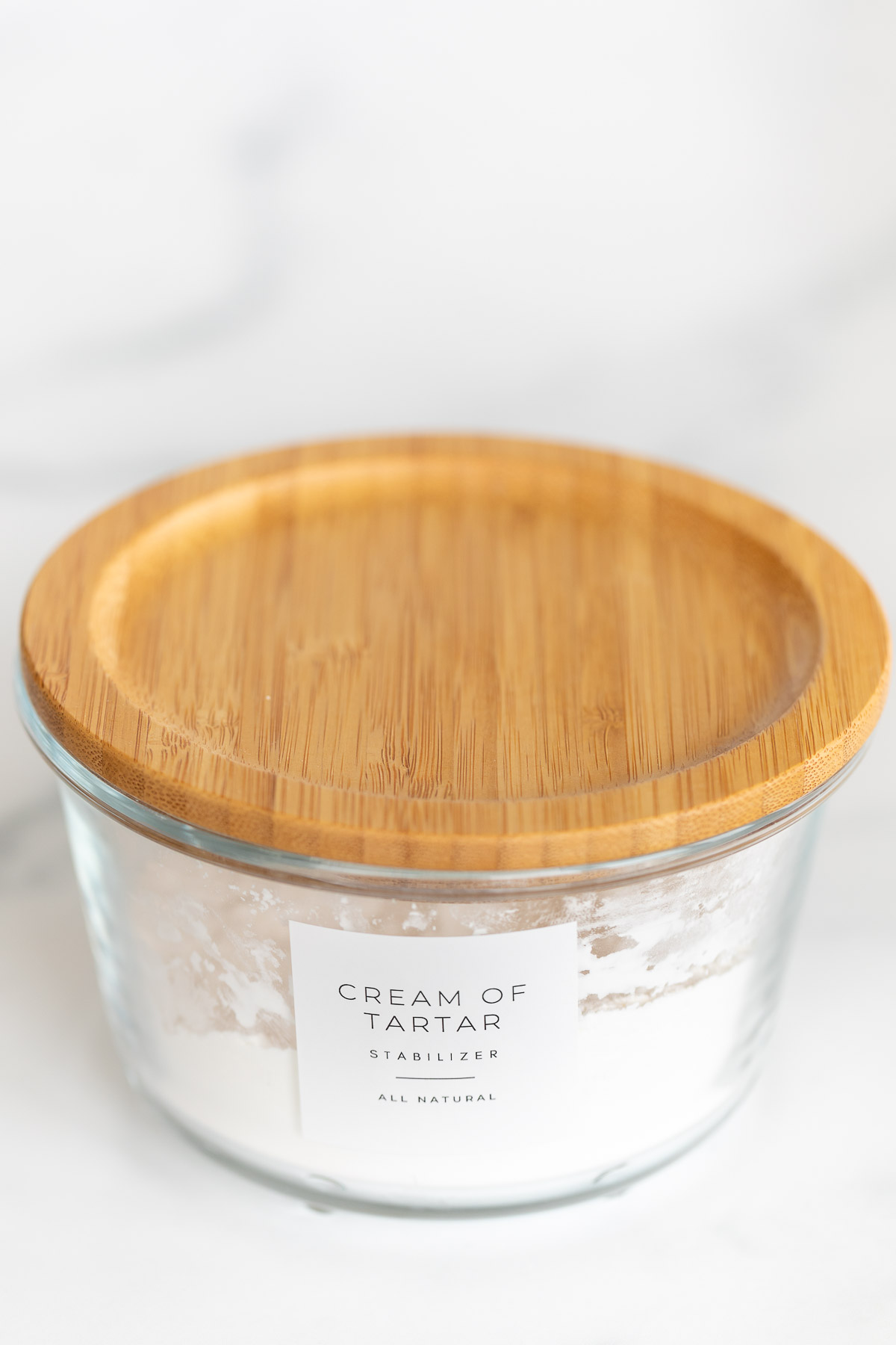 cream of tartar in glass container with wood lid and label