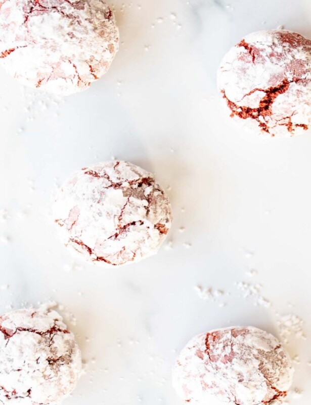 Red Velvet Crinkle Cookies on a marble counter