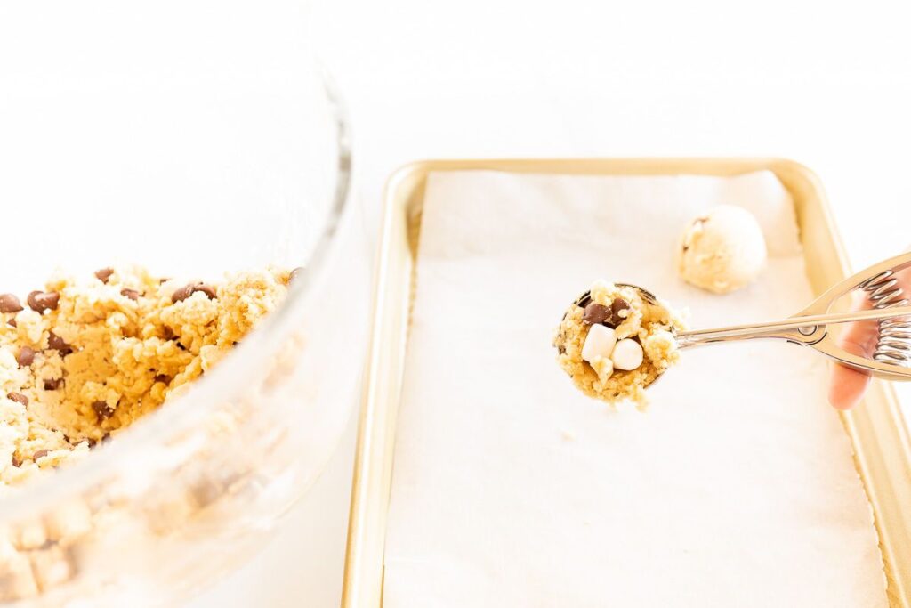 A cookie scoop, scooping marshmallow cookie dough