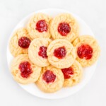 A white plate filled with strawberry cheesecake cookies.