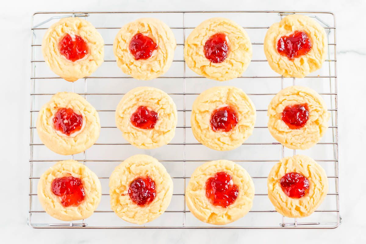 Strawberry cheesecake cookies on a wire cooling rack.