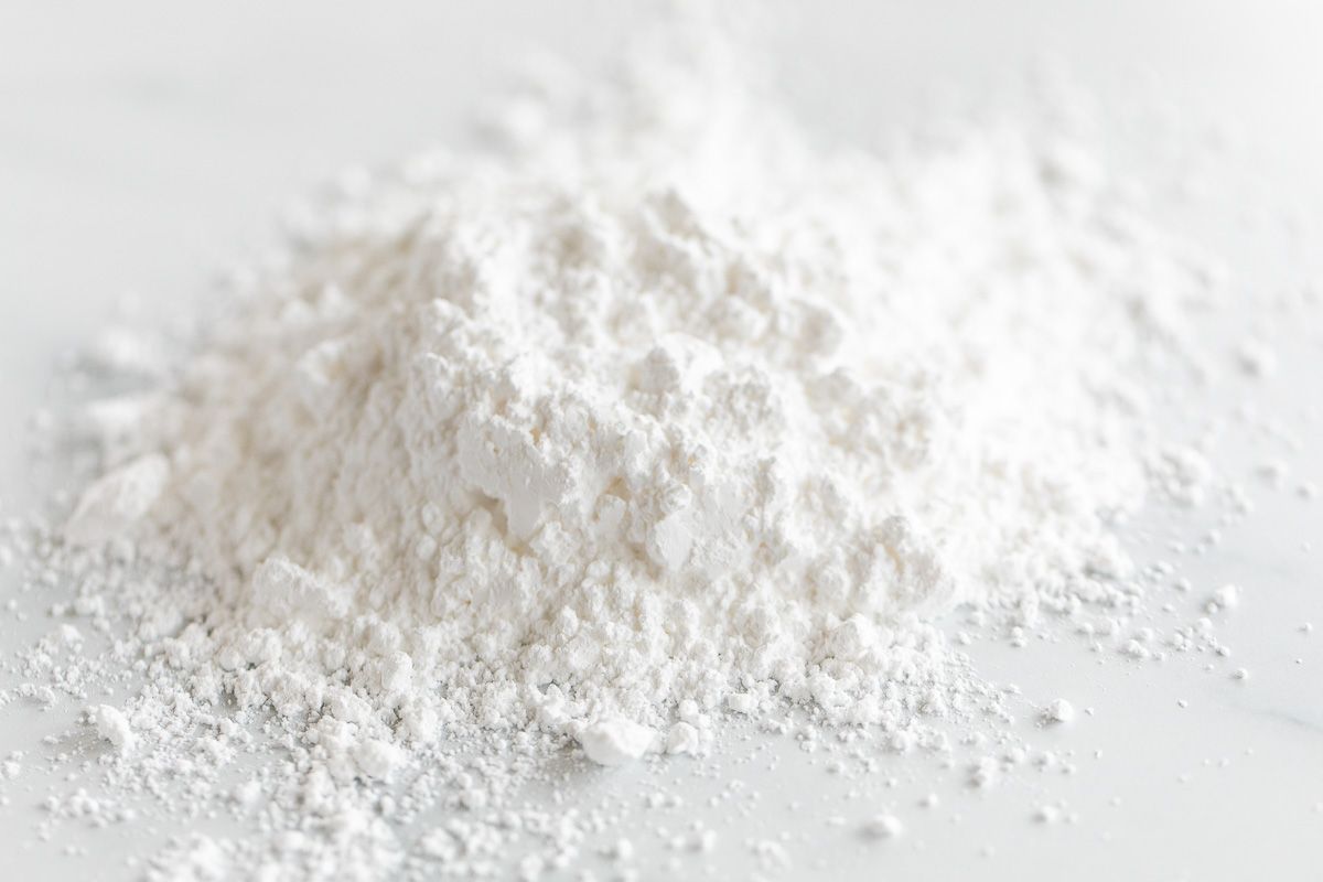 confectioner's powdered sugar on a white marble countertop