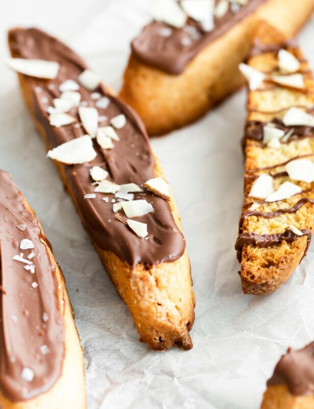 Vanilla biscotti on a marble surface, topped in chocolate