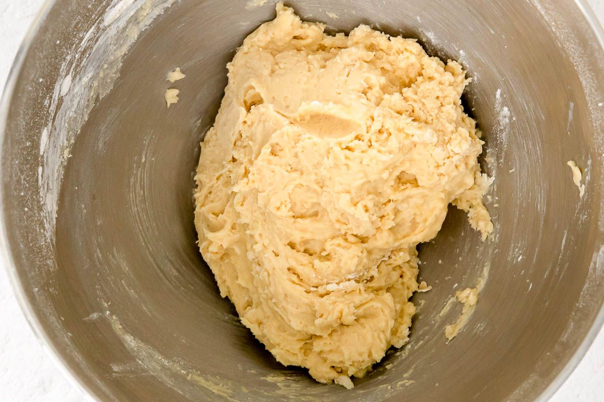 Vanilla biscotti cookie dough inside a stainless steel bowl.