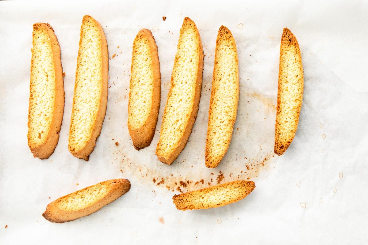 Vanilla biscotti laid out on a white surface.