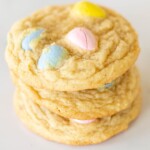 A stack of multiple mini egg cookies, on a marble surface for Easter.