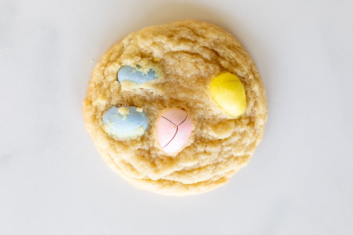 A mini egg cookie on a marble surface.