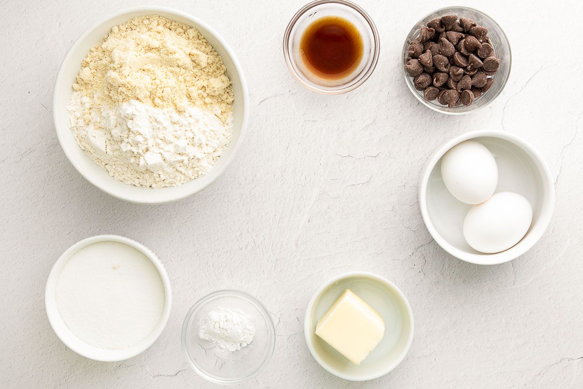 Vanilla biscotti ingredients laid out on a white marble countertop.