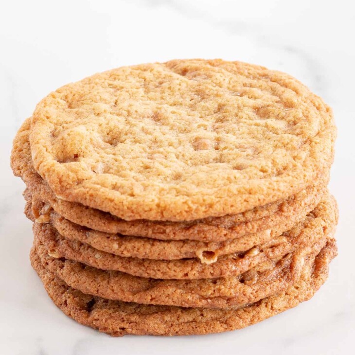brown butter toffee cookies stacked on a marble surface