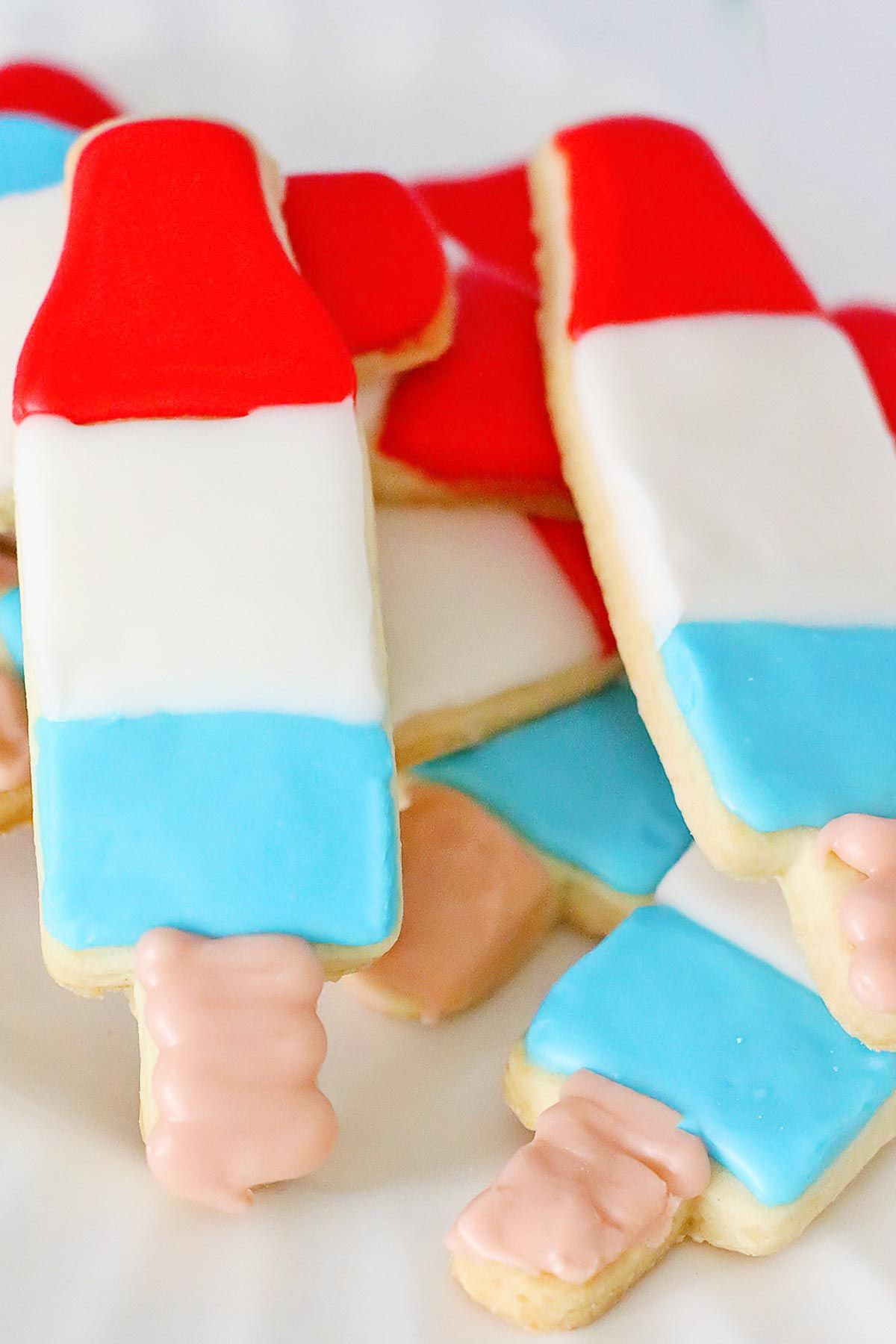 Bomb pop 4th of July sugar cookies on a white plate