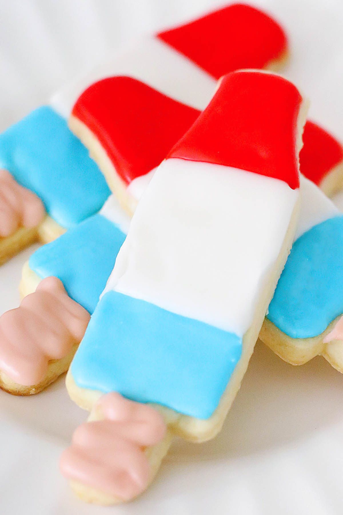 Bomb pop 4th of July sugar cookies on a white plate