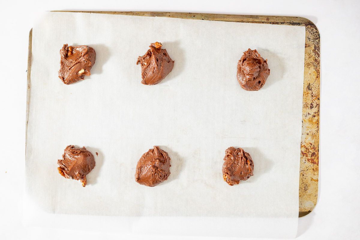 Texas sheetcake cookie dough balls on a baking sheet lined with parchment paper