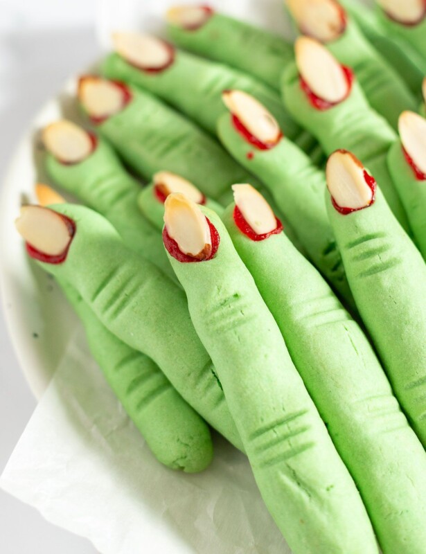 Green which finger cookies piled onto a platter on a marble surface