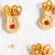 Peanut butter reindeer cookies on a baking sheet lined with parchment.