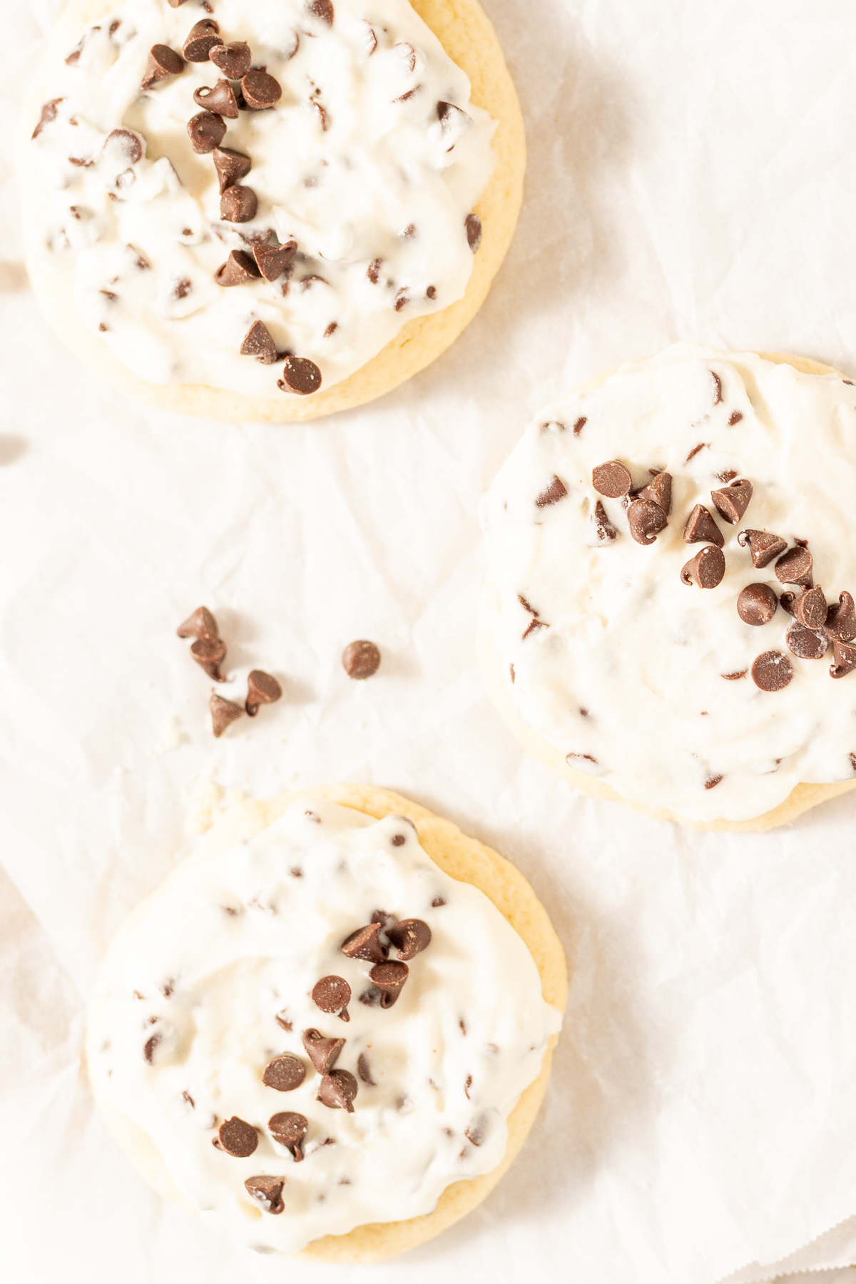 Cannoli cookies on a parchment lined baking sheet.
