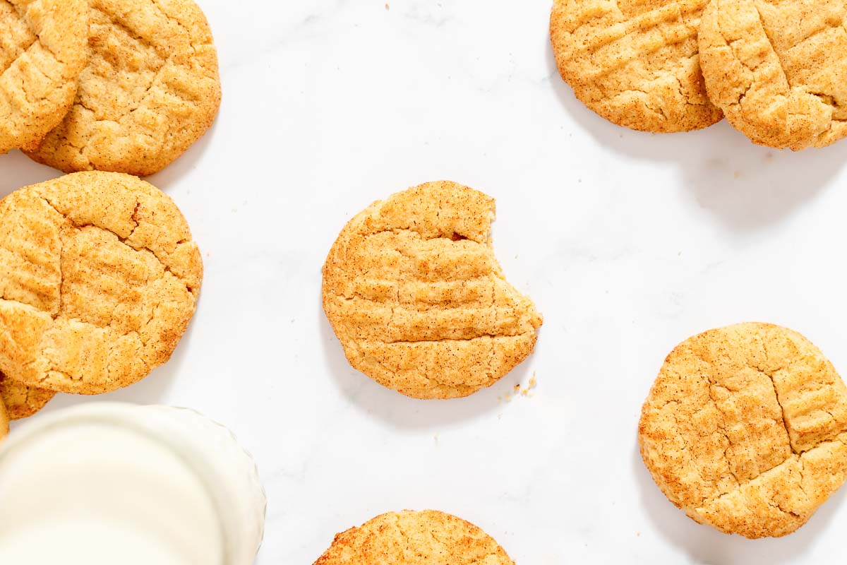 Overhead view of peanut butter snickerdoodles with glass of milk