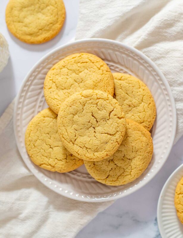 Overhead view of egg yolk cookies on white plate
