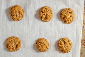 Overhead view of oatmeal cookies without butter on parchment lined baking sheet